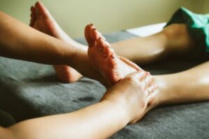 A podiatrist performs reflexology for foot pain.