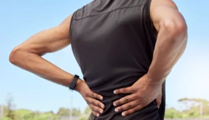A patient suffering from lower back pain due to having one leg longer than the other